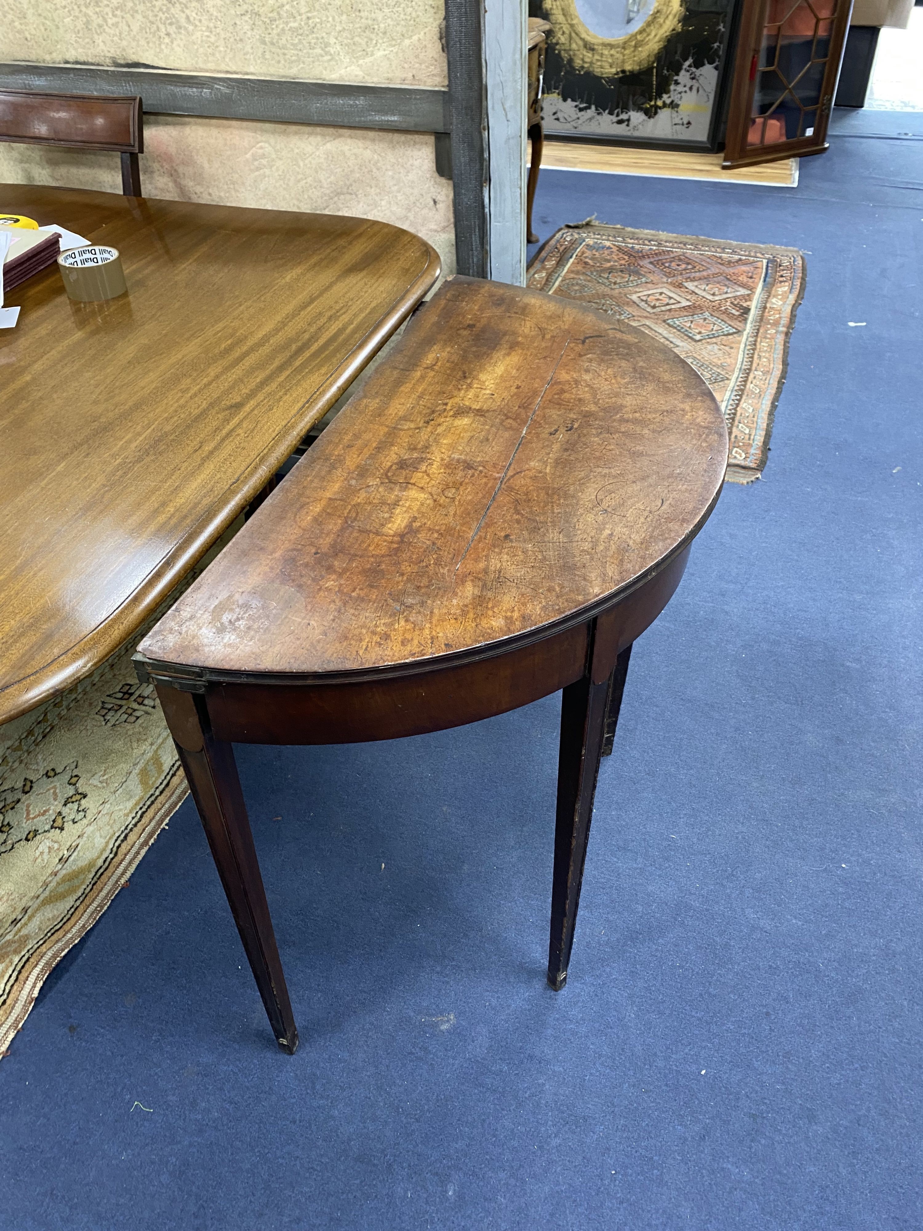 A George III mahogany 'D' shaped folding card table (top split), width 90cm, depth 46cm, height 74cm